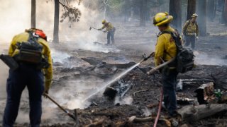 Firefighters putting out Caldor Fire hot spots