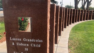 A plaque honors Lauren Grandcolas, who died on United Flight 93, in Union City, Calif., Aug. 17, 2021. Twenty years later, Jack Grandcolas still remembers waking up at 7:03 that morning. He looked at the clock, then out the window where an image in the sky caught his eye — a fleeting vision that looked like an angel ascending. He didn’t know it yet, but that was the moment his life changed. Across the country, it was 10:03 a.m. and United Flight 93 had just crashed into a Pennsylvania field. His wife, Lauren, was not supposed to be on that flight.