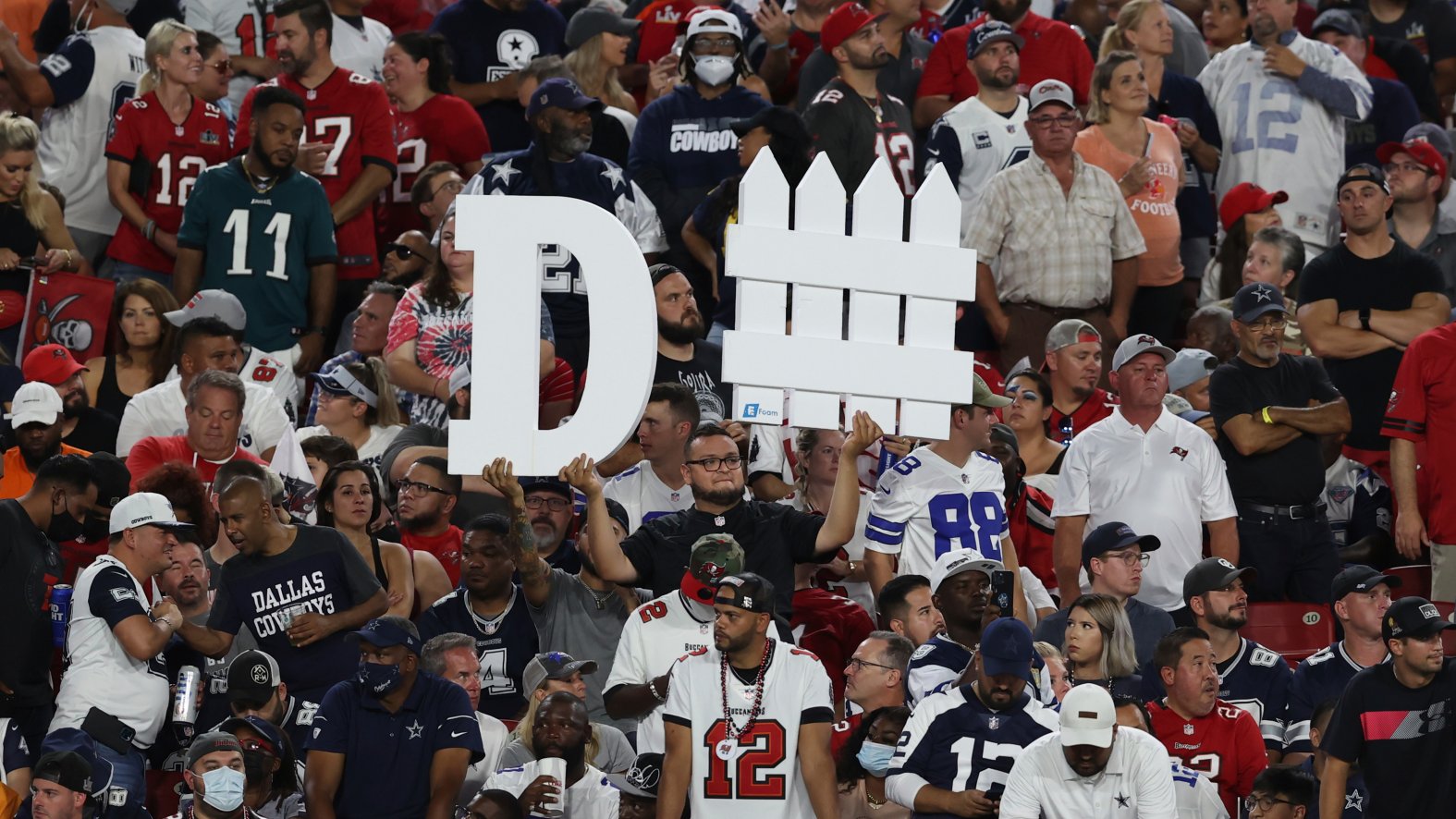 A Tampa Bay Buccaneers fan holds a sign during the first half of an NFL foo...