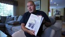 Will Jimeno holds the children's book he wrote, "Immigrant, American, Survivor."