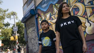 Monica Muquinche and her son Sebastian pose for a photo in their neighborhood in the Brooklyn borough of New York