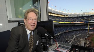In this Sept. 25, 2009, file photo, New York Yankees broadcaster John Sterling sits in the booth before the Yankees' baseball game
