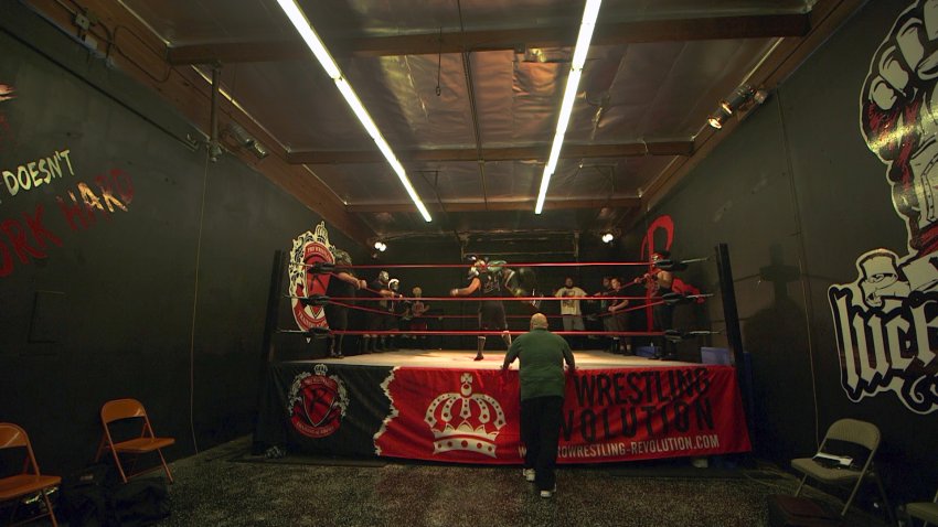 Gabriel Ramirez, founder of Pro Wrestling Revolution in San Jose watches his wrestling students practice moves during a recent class.