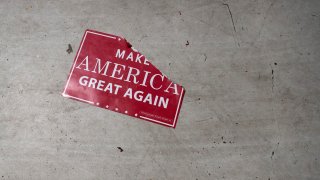 a "Make America Great Again" sign sits on the floor
