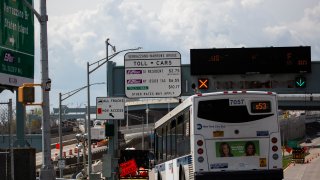 A Metropolitan Transportation Authority (MTA) New York City public bus approaches the Verrazzano-Narrows Bridge in New York