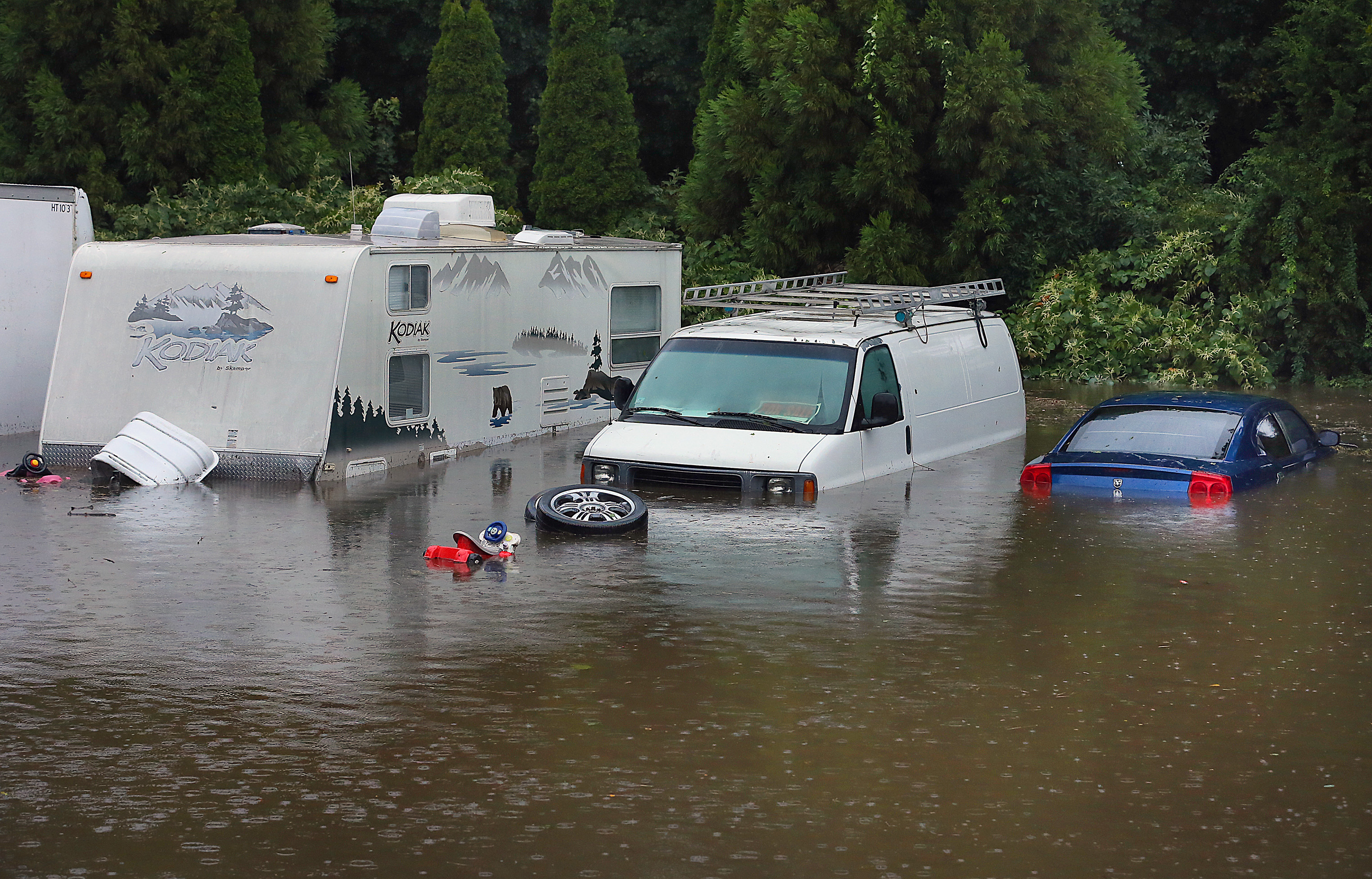 Vehicles are surrounded by water behind an apartment building on Main Street in Kingston, MA on Sept. 2, 2021. Flooding concerns due to the heavy rainfall from the remnants of Hurricane Ida shifted away from morning commute problems to communities along rivers in both Massachusetts and Rhode Island, where water levels were continuing to rise on Thursday. The overnight rainfall reached nearly 6 inches in some Massachusetts communities.