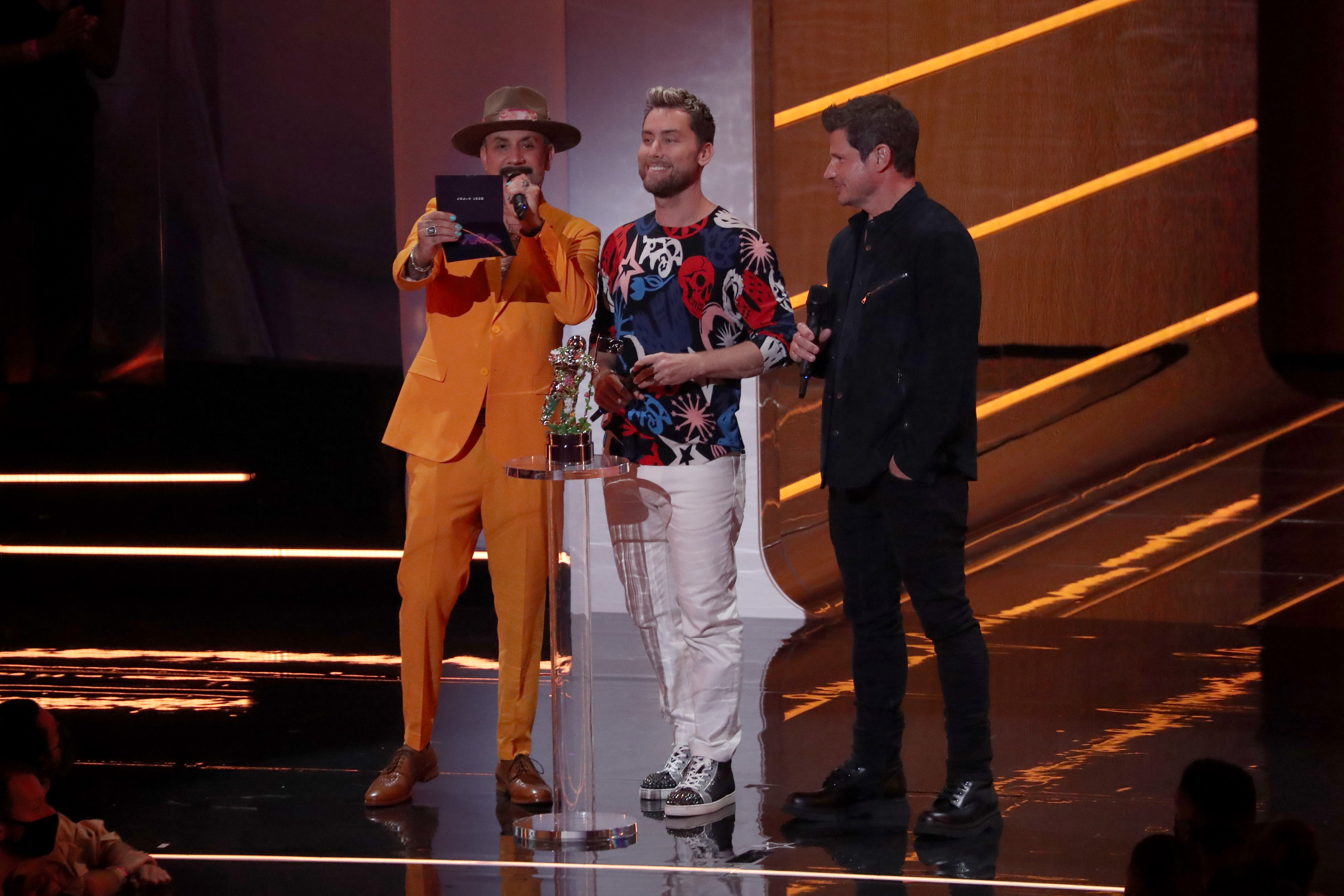 NEW YORK, NEW YORK – SEPTEMBER 12: (L-R) AJ McLean, Lance Bass, and Nick Lachey speak onstage during the 2021 MTV Video Music Awards at Barclays Center on September 12, 2021 in the Brooklyn borough of New York City. (Photo by Bennett Raglin/Getty Images)