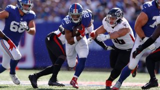 Saquon Barkley #26 of the New York Giants runs the ball during the third quarter in the game against Atlanta Falcons at MetLife Stadium on September 26, 2021 in East Rutherford, New Jersey.