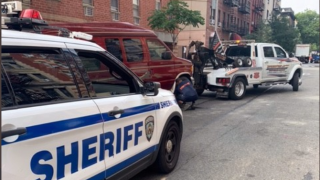 A van towed by city authorities allegedly illegally registered and used as an Airbnb rental.