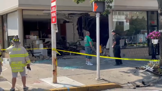 Caution tape cordons off a salon in Great Neck where a car drove through the front of the business.