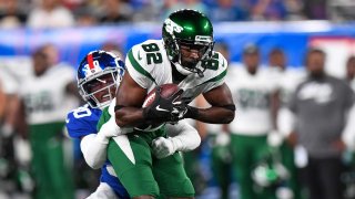 New York Jets wide receiver Jamison Crowder (82) runs the ball against New York Giants cornerback Darnay Holmes (30) during the first half at MetLife Stadium.