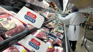 Pork products are displayed on a shelf at a Safeway store