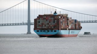 A cargo ship filled with containers moves through New York Harbor as it heads out to the Atlantic ocean on October 12, 2021 in New York City.