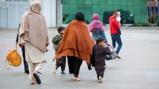 U.S.-affiliated Afghans arrive at the Pristina International Airport in Kosovo