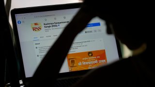 A girl looks at the face book page of Rashtriya Swayamevak Sangh or RSS, in New Delhi, India