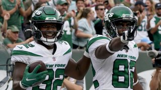 New York Jets wide receiver Jamison Crowder (82) celebrates his touchdown with running back Michael Carter (32) during the second half of an NFL football game against the Tennessee Titans