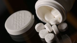 Aspirin tablets spilled from a bottle. 25 April 2002