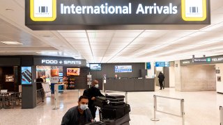 Passengers wearing masks as they arrive at Dulles International Airport.