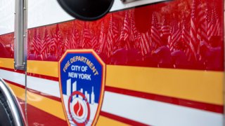 American flags are reflected off a fire truck in New York City