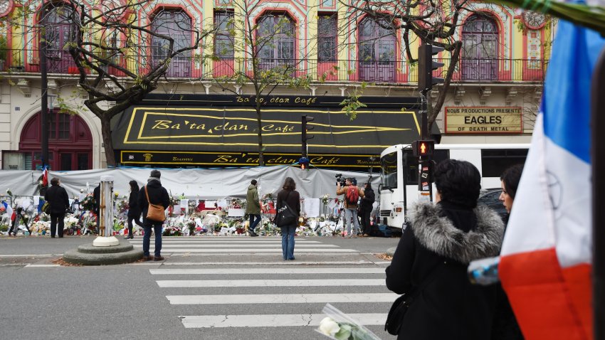People gather in front of the Bataclan concert hall on November 27, 2015 in Paris during a national tribute to the 130 people killed in the November 13 Paris attacks. AFP PHOTO / ALAIN JOCARD / AFP / ALAIN JOCARD        (Photo credit should read ALAIN JOCARD/AFP via Getty Images)