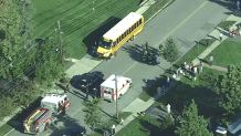 Emergency vehicles surround a school bus after crashing with a car that failed to yield at a stop sign, police say.