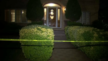 Police tape cordons off the front of a Staten Island home on Burbank Avenue where the department says a son shot and killed his mother.