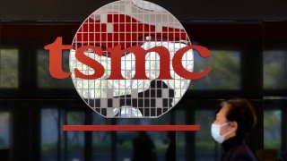 A man walks past TSMC’s logo at the company’s headquarters in Hsinchu, Taiwan.