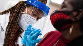 UNITED STATES – OCTOBER 4: Hattie Pierce, 75, receives a Pfizer covid-19 vaccine booster shot from Dr. Tiffany Taliaferro at the Safeway on Capitol Hill in Washington, D.C., on Monday, October 4, 2021. (Photo By Tom Williams/CQ-Roll Call, Inc via Getty Images)