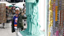 Josiah McNickles, 6, a tourist from San Francisco, looks at replica of the Statue of Liberty at Grand Slam, a souvenir and sports apparel store, in Times Square