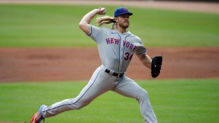 FILE - New York Mets pitcher Noah Syndergaard works against the Atlanta Braves in the first inning of a baseball game
