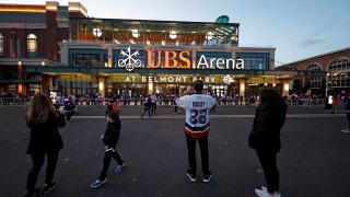 Fans wait to get in the new UBS Arena for the first New York Islanders NHL hockey game against the Calgary Flames on Saturday