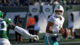 Miami Dolphins quarterback Tua Tagovailoa looks to throw during the first half of an NFL football game against the New York Jets