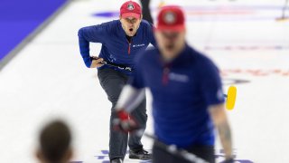 Team Shuster's John Shuster yells to his teammates as they sweep to curl the rock he threw while competing against Team Dropkin during the third night of finals at the U.S. Olympic Curling Team Trials at Baxter Arena in Omaha, Neb., Sunday, Nov. 21, 2021.