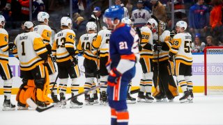 Pittsburgh Penguins' players celebrates after defeating the New York Islanders during an NHL hockey game, Friday, Nov. 26, 2021, in Elmont, N.Y.