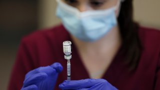 Boston, MA - November 9: A registered nurse draws up a dose of the Pfizer COVID-19 booster at Park Avenue Health Center in Arlington, MA on November 9, 2021. Nursing home leaders are now facing another sobering reality. Immunity is waning from COVID shots administered to many of their residents and staff early this year. Just 27 percent of nursing home staffers had received boosters by late October, and now many nursing homes are trying to convince workers to get their boosters. In hopes of creating as much protection in their facility as possible, Park Avenue is offering boosters to any staff, resident or residents' family members who want them.