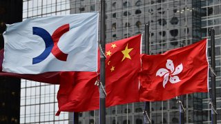 From left, the flags of the Hong Kong Stock Exchange, China and Hong Kong are seen flapping in the wind on May 6, 2019.