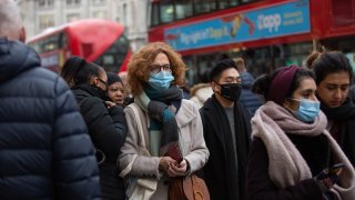 Shoppers wearing face masks as a preventive measure against the spread of covid-19 seen walking along Oxford Circus in London.