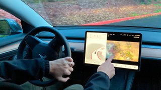 Tesla owner demonstrates on a closed course in Portland, Ore., how he can play video games on the vehicle's console while driving.