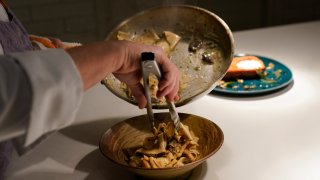 In this photo, Amy Brandwein, chef and owner of Centrolina, prepares a dish in her restaurant kitchen, Thursday, Dec. 16, 2021, in Washington.