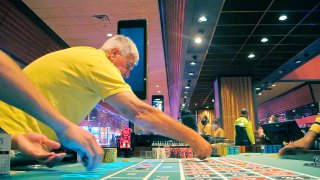 This June 23, 2021 photo shows a gamblers placing a bet on a roulette table at Bally’s casino in Atlantic City, N.J.