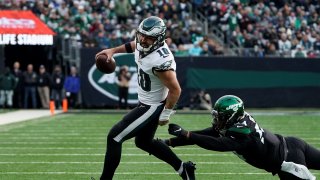 Philadelphia Eagles quarterback Gardner Minshew (10) breaks away from New York Jets defensive lineman Ronald Blair, right, during the second half of an NFL football game, Sunday, Dec. 5, 2021, in East Rutherford, N.J.