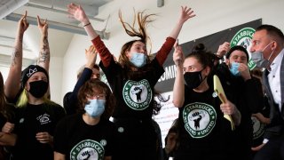 Starbucks employees and supporters react as votes are read during a viewing of their union election on Thursday, Dec. 9, 2021, in Buffalo, N.Y.