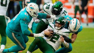 New York Jets quarterback Zach Wilson (2) is sacked by Miami Dolphins defensive end Emmanuel Ogbah (91) and inside linebacker Andrew Van Ginkel (43) during the second half of an NFL football game, Sunday, Dec. 19, 2021, in Miami Gardens, Fla.
