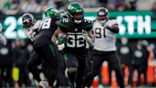 New York Jets running back Michael Carter (32) runs against the Jacksonville Jaguars during an NFL football game, Sunday, Dec. 26