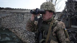 A Ukrainian serviceman patrols at the checkpoint in the village of Shyrokyne near Mariupol, the last large city in eastern Ukraine controlled by Kiev