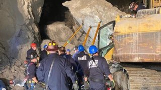 Crews stabilized the boulder, and then worked to get the worker, who was receiving care from paramedics, officials said