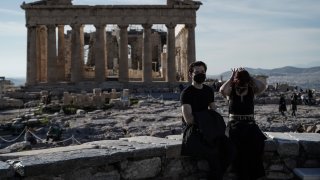 Tourists visit the Acropolis archaeological site in Athens, Greece, on Tuesday, Jan. 4, 2022.