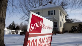 A “Sold” sign stands outside a home following a snow fall in Geneseo, Illinois.