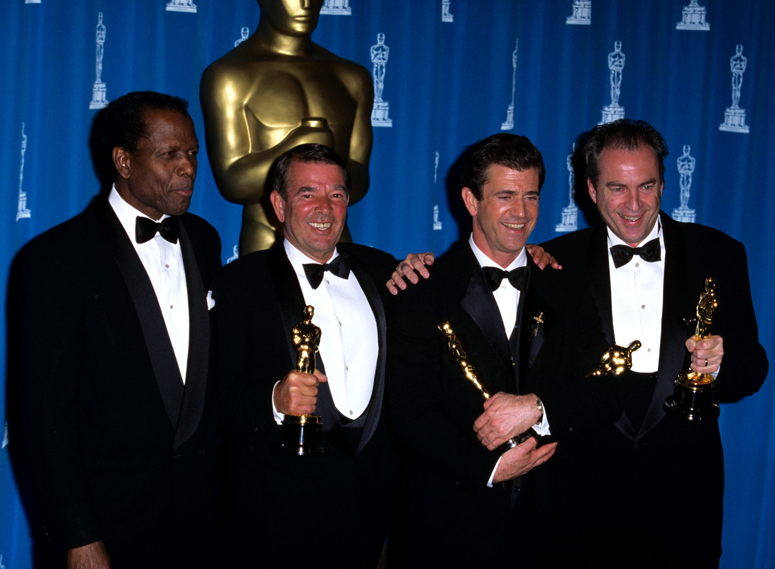 From left: Sidney Poitier, presenter of the Academy Award for “Best Picture,” poses with winners Alan Ladd JR., Mel Gibson and Bruce Davey at the 68th Academy Awards, March 25, 1996.