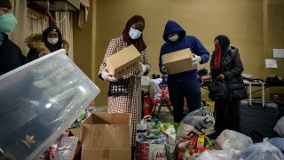 Volunteers prepare donations of clothes